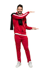 Full-length shot of Handsome sportman holding copyspace to insert an ad on isolated white background