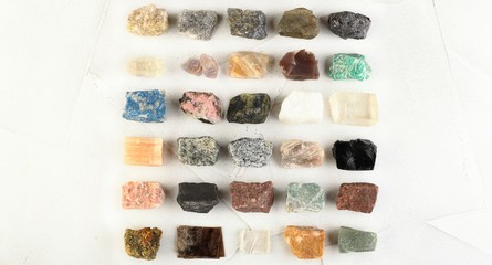 Set of minerals, a collection of rocks, minerals in the box on white cement background.
