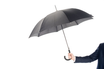 cropped view of businessman holding black umbrella isolated on white