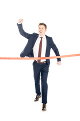 successful young businessman running to red finishing line isolated on white