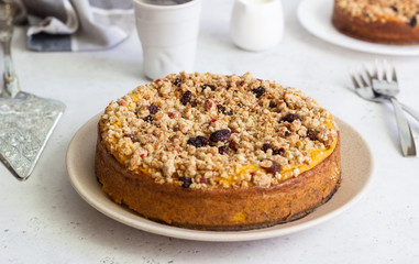 Cheesecake with pumpkin and crumble. No crust cheesecake. Healthy dessert. Light concrete background. Copy space.