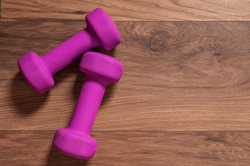 dumbbells on a wooden background in a gym. healthy and lifestyle. Empty space for your advertising text. Sport concept.