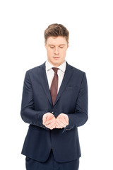 young businessman holding something in palms isolated on white