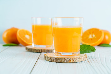 Fresh orange juice on wood background