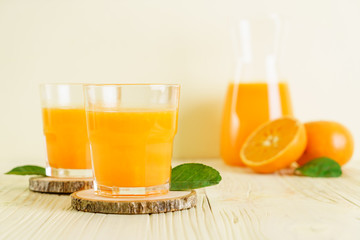 Fresh orange juice on wood background