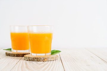 Fresh orange juice on wood background