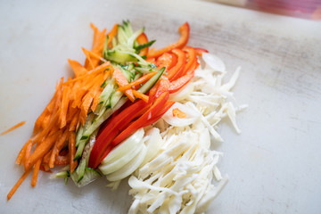 Chef cuts the vegetables into a meal. Preparing dishes. A man uses a knife and cooks.