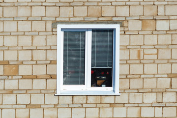 plastic window in a brick house