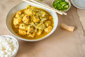 Chicken with cabbage in a curry sauce in a large bowl and a cup of rice, chopsticks - Japanese cuisine