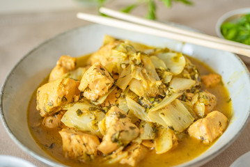 Chicken with cabbage and curry sauce in a large bowl and chopsticks - Thai cuisine