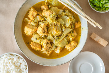 Chicken with cabbage in a curry sauce in a large bowl and a cup of rice, chopsticks - Japanese cuisine