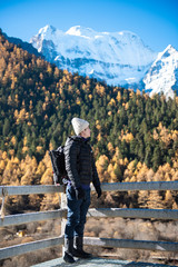 Fototapeta na wymiar A hiking man is enjoying in snow peak mountain at autumn, People traveling concept
