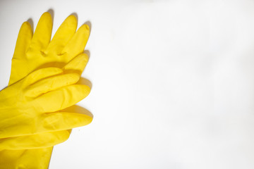 Yellow rubber gloves for cleaning on white background, workhouse concept