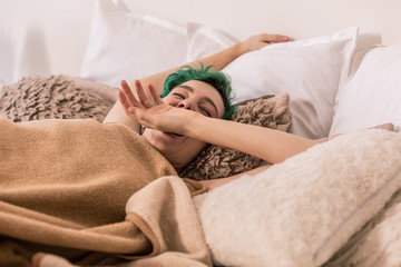 Woman yawning while waking up early in the morning