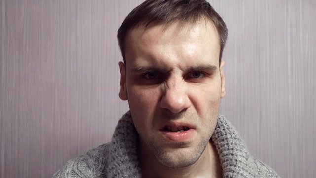 An adult aggressive man with a nervous face loses his temper