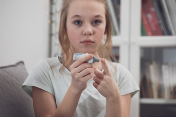  diabetic girl checking blood sugar level