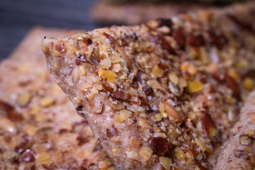 Integral crackers with healthy seeds: linseeds, chia, cracked pumpkin seeds, sunflower, sesame and spices with whole wheat flour. Macro photography