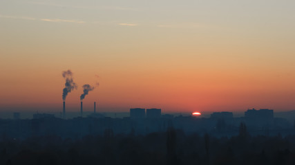 Fototapeta na wymiar Factory smoke at sunset sky