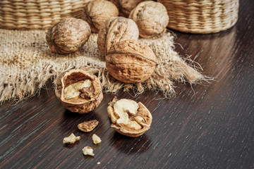 Walnuts on a dark wooden table with rustic background