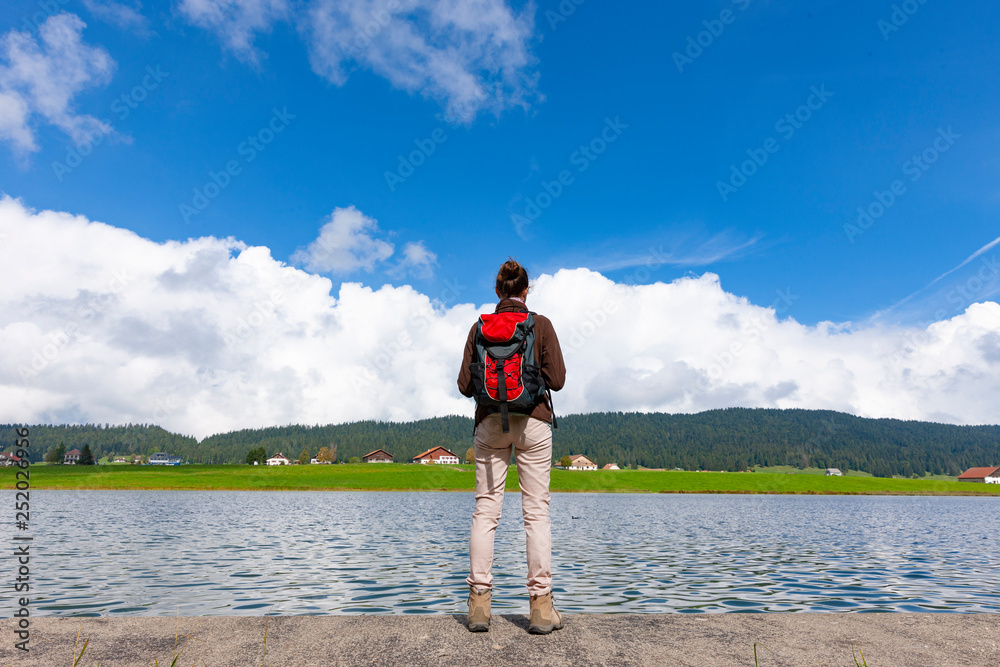 Wall mural woman hiking at a lake