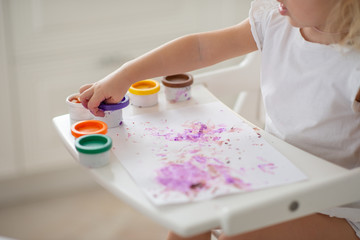 the child draws finger paints close-up of the hand