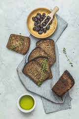 Whole wheat bread baked at home and dried olives