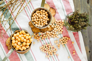 Chickpeas dry and boiled in an iron bowl, thyme. Rustik style background. Top view. Kinfolk and comfort food atmosphere concept.