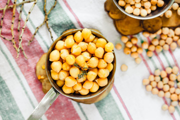 Chickpeas dry and boiled in an iron bowl, thyme. Rustik style background. Top view. Kinfolk and comfort food atmosphere concept.