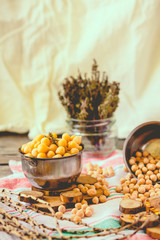 Dried and boiled chickpeas. Vegetarian protein. Dry thyme sprigs in a jar. Healthy lifestyle and balanced food concept. Selective focus.Toning.