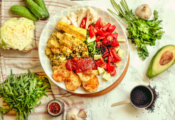Green fresh salad with tomatoes, pink lentil mashed potatoes, baked potato slices with homemade ketchup.Vegetarian colorful lunch. Top view.