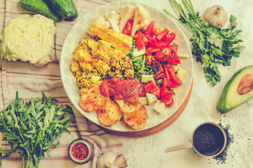 Green fresh salad with tomatoes, pink lentil mashed potatoes, baked potato slices with homemade ketchup.Vegetarian colorful lunch. Top view.Toning.