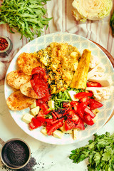 Green fresh salad with tomatoes, pink lentil mashed potatoes, baked potato slices with homemade ketchup.Comfort food concept. Top view.