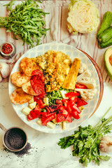 Green fresh salad with tomatoes, pink lentil mashed potatoes, baked potato slices with homemade ketchup.Comfort food concept. Top view.