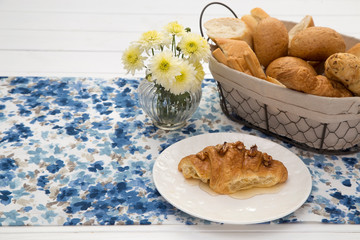 Continental breakfast with fresh croissants, bread on table