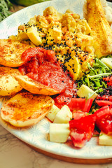 Green fresh salad with tomatoes, pink lentil mashed potatoes, baked potato slices with homemade ketchup.Comfort food concept. Selective focus.Close-up.