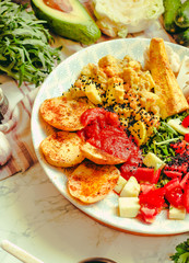 Green fresh salad with tomatoes, pink lentil mashed potatoes, baked potato slices with homemade ketchup..Healthy lifestyle and balanced food concept. Selective focus