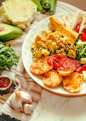 Green fresh salad with tomatoes, pink lentil mashed potatoes, baked potato slices with homemade ketchup..Healthy lifestyle and balanced food concept. Selective focus