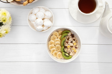 Breakfast with oatmeal porridge on wooden table. Healthy breakfast concept. Top view
