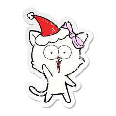 distressed sticker cartoon of a cat wearing santa hat