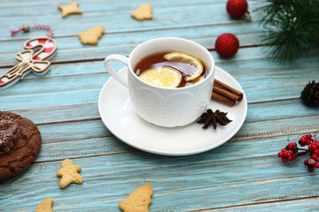 Cup of tea and cookies on wooden table. Christmas, winter xmas concept. Flat lay top view.