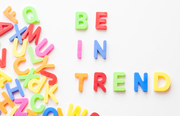 Trends concept. Coloured letters on white background. Be in trend