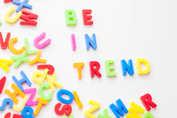 Trends concept. Coloured letters on white background. Be in trend