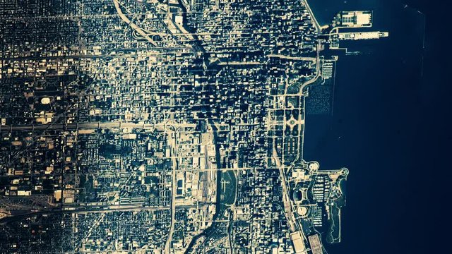 Aerial satellite view of sunset shadow on city of chicago harbor animation. Contains public domain image by Nasa