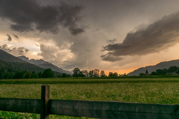 Fototapeta premium Storm clouds over the mountains near the town of Ratece in the Julian Alps, Slovenia