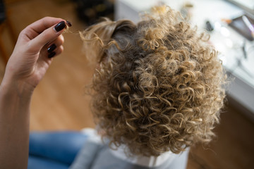 blonde hair curls close-up in beauty salon