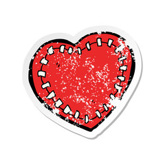 retro distressed sticker of a cartoon stitched heart