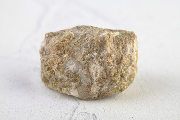 Sulfur in rock from Gaurdak, Turkmenistan on white cement background. Sulfur Mineral.