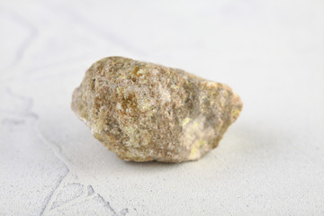 Fototapeta na wymiar Sulfur in rock from Gaurdak, Turkmenistan on white cement background. Sulfur Mineral.