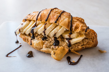 Croissant Sandwich with Banana, Peanut Butter and Chocolate Sauce.