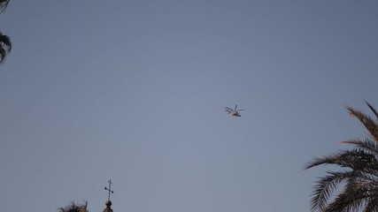 Helicopter flying through the city on a sunny day